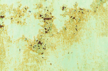 Background of rusty metal painted in green paint.