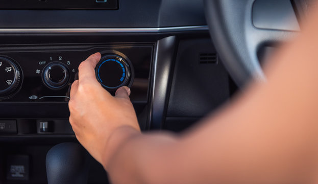 Close-up portrat of woman hand turning on car air conditioning system, Increase,decrease air flow
