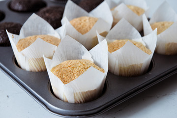 Tasty cupcakes on background table. Homemade chocolate muffin cupcake with cream buttercream icing. Birthday cupcake. Valentine cupcake sweets. Close up view delicious sweet dessert