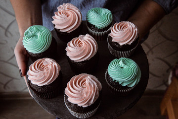 Tasty cupcakes on background table. Homemade chocolate muffin cupcake with cream buttercream icing. Birthday cupcake. Valentine cupcake sweets. Close up view delicious sweet dessert