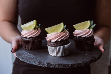 Tasty cupcakes on background table. Homemade chocolate muffin cupcake with cream buttercream icing. Birthday cupcake. Valentine cupcake sweets. Close up view delicious sweet dessert