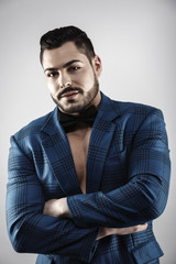 Fototapeta premium Handsome muscular young bodybuilder showing his muscles and abs while posing shirtless