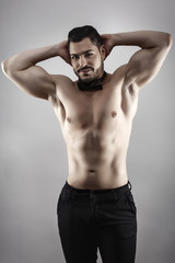 Fototapeta na wymiar Handsome muscular man posing in studio