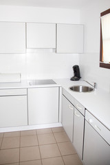 Fototapeta na wymiar interior of small white kitchen clean and bright