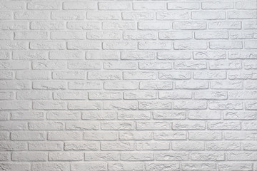 Fototapeta na wymiar Wall from a white brick with a regular laying