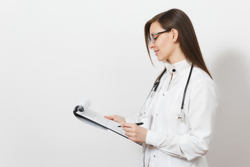 Pretty confident young doctor woman with stethoscope, glasses isolated on white background. Female doctor in medical gown holding health card on notepad folder. Healthcare personnel, medicine concept.