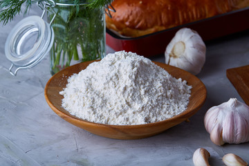 Preparation for cooking, plate with salt with garlic and dill over white background, close-up, selective focus