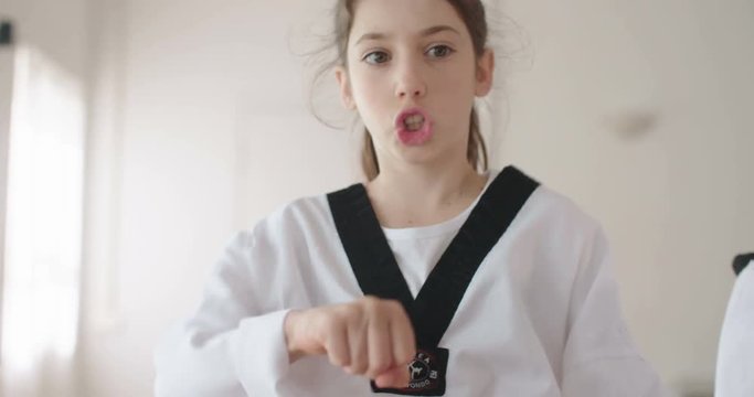 Slow motion footage of a girl practicing martial arts