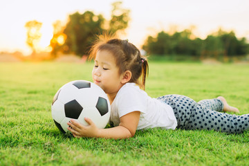 kids playing soccer football for exercise on the green grass field