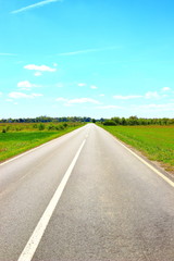 Empty road direction, blue sky in background