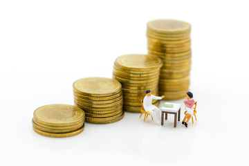 Miniature people: Business consultants on financial transactions. Image use for financial, business concept.