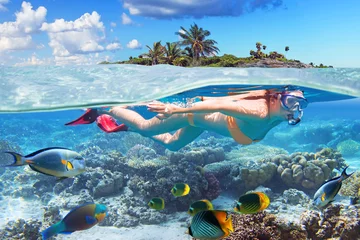 Rolgordijnen Young woman at snorkeling in the tropical water © Patryk Kosmider