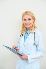 adult smiling doctor with clipboard on white