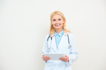 happy female doctor with digital tablet on white