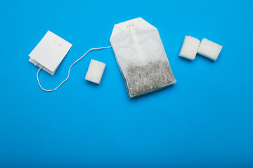 White tea bag with sugar cubes. Copy space.