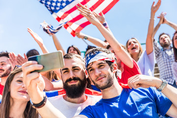 American fans taking a selfie at stadium during a match