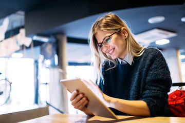 Portrait of young attractive woman using tablet