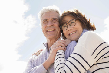 Portrait of senior couple embracing by the beach