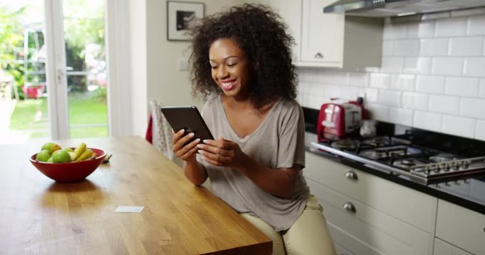 An attractive woman does her online shopping on her digital tablet