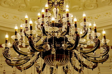 large crystal chandelier vintage glowing in the form of candelabra candlesticks and candlesticks...