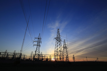 A high voltage substation in the sky at sunrise