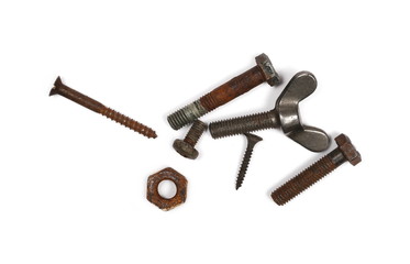 Pile of old rusty screw heads, bolts, metal nuts and parts, isolated on white background, top view