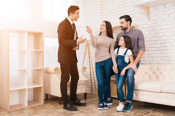 Realtor in suit shows family house they bought. Concept of buying house. Buying real estate.