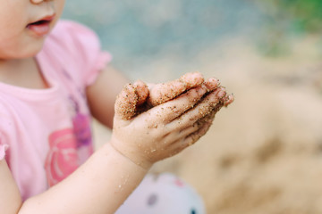Kids playing in the sands. This activity is good for sensory experience and learning by touch their fingers and toes through sand and enjoying its texture.