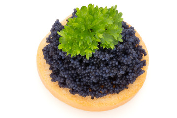 Canapes with black sturgeon caviar and  parsley. Isolated on the white background.