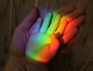 family hands and rainbow