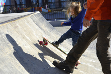 little girl riding a skateboard