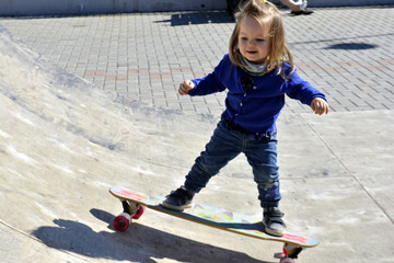 little girl riding a skateboard