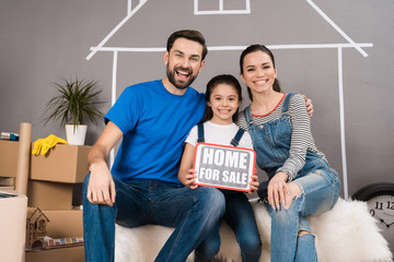 Real estate concept. Concept of house selling. Happy family sells house.