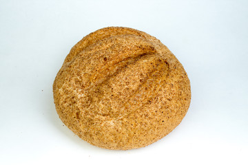 Many mixed breads and rolls of baked bread, on wooden table background.