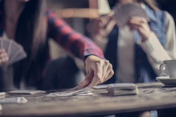 Girls playing game cards. Close up.