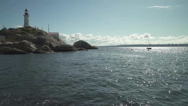 Point Atkinson Lighthouse and Sailboat 4K UHD. Historic Point Atkinson Lighthouse, overlooking Georgia Strait. Vancouver, British Columbia, Canada. 4K UHD.
