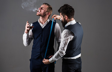 Man with beard holds measuring tape. Tailor taking measurements