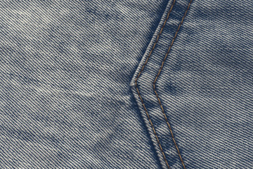 a large seam in the form of an arrow on a denim blue fabric
