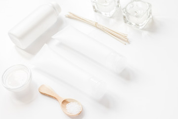 Fototapeta na wymiar white set of cosmetics for spa on table background
