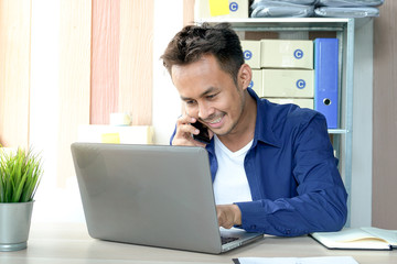 Young business owner of the SME start up company are get purchase orders from customers in the online trading business with a computer laptop in the Home Office