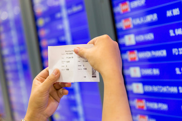 passenger  in airport look at flight timetable