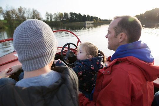 Cousins with niece in a boat