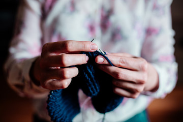 Knitting by women's hands.