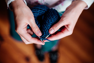 Knitting by women's hands.