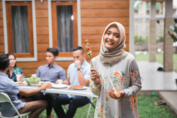 muslim woman barbecue with friends