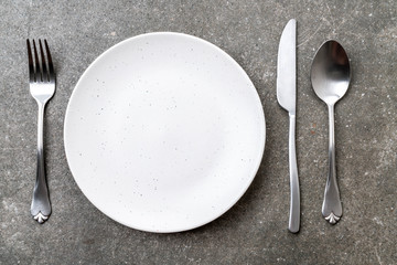 empty plate spoon fork and knife