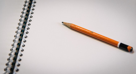 detail of open ring binder with pencil, pen