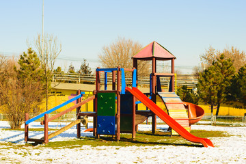 Fototapeta na wymiar Vivid colors, empty childrens playground in winter time.