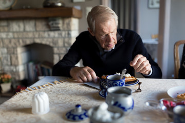 Senior man with mental disability eating waffle