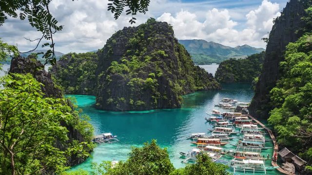 Coron island, Palawan, Philippines, time lapse view of Kayangan Lake viewpoint showing tourist outrigger boats and karst scenery. 